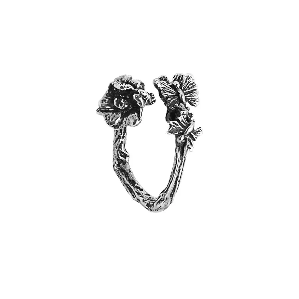 Anello contrariè aperto in argento brunito con fiore di ciliegio e farfalline